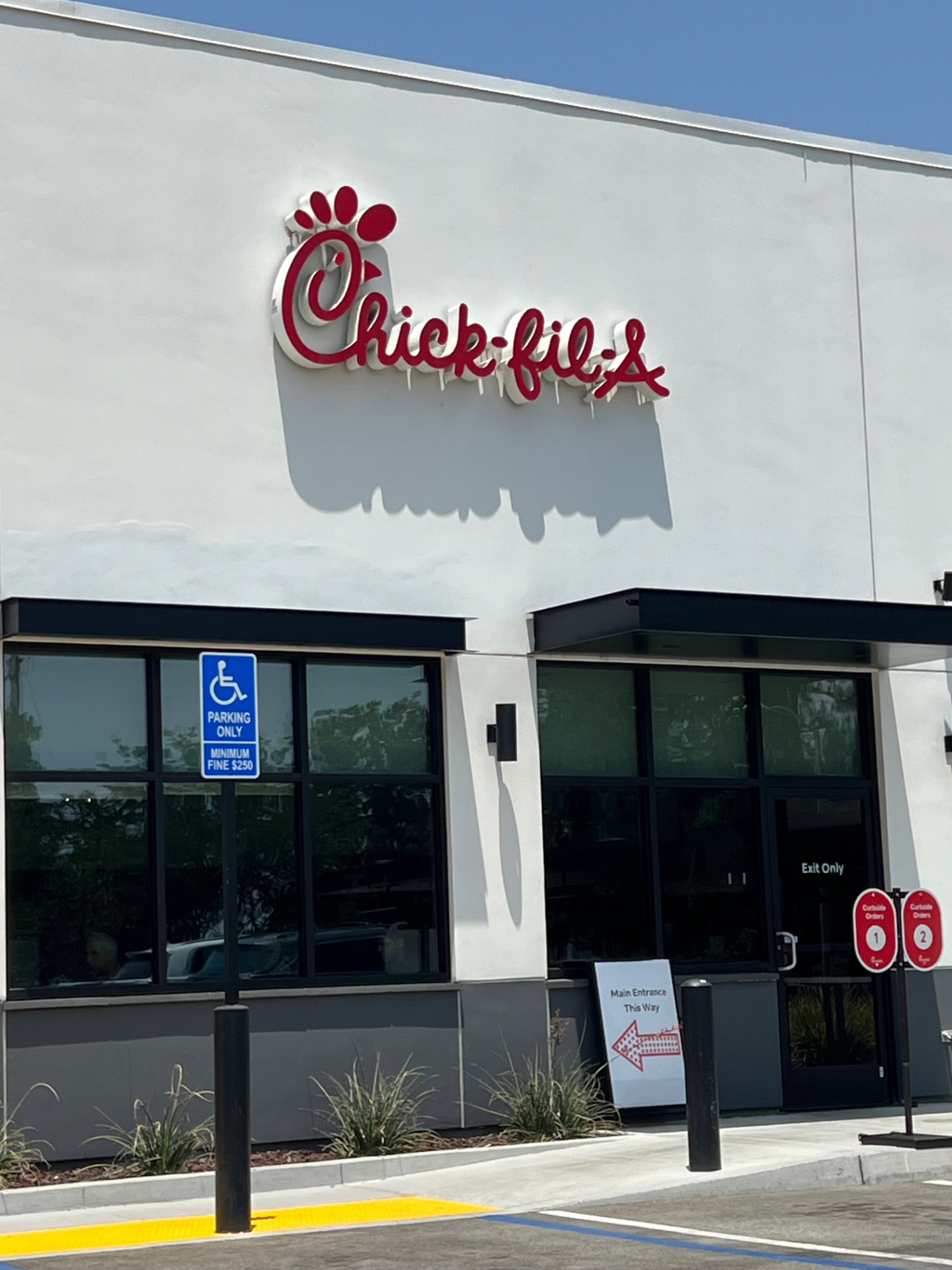 Chick-fil-A dimensional channel-letter logo mounted on a white storefront facade